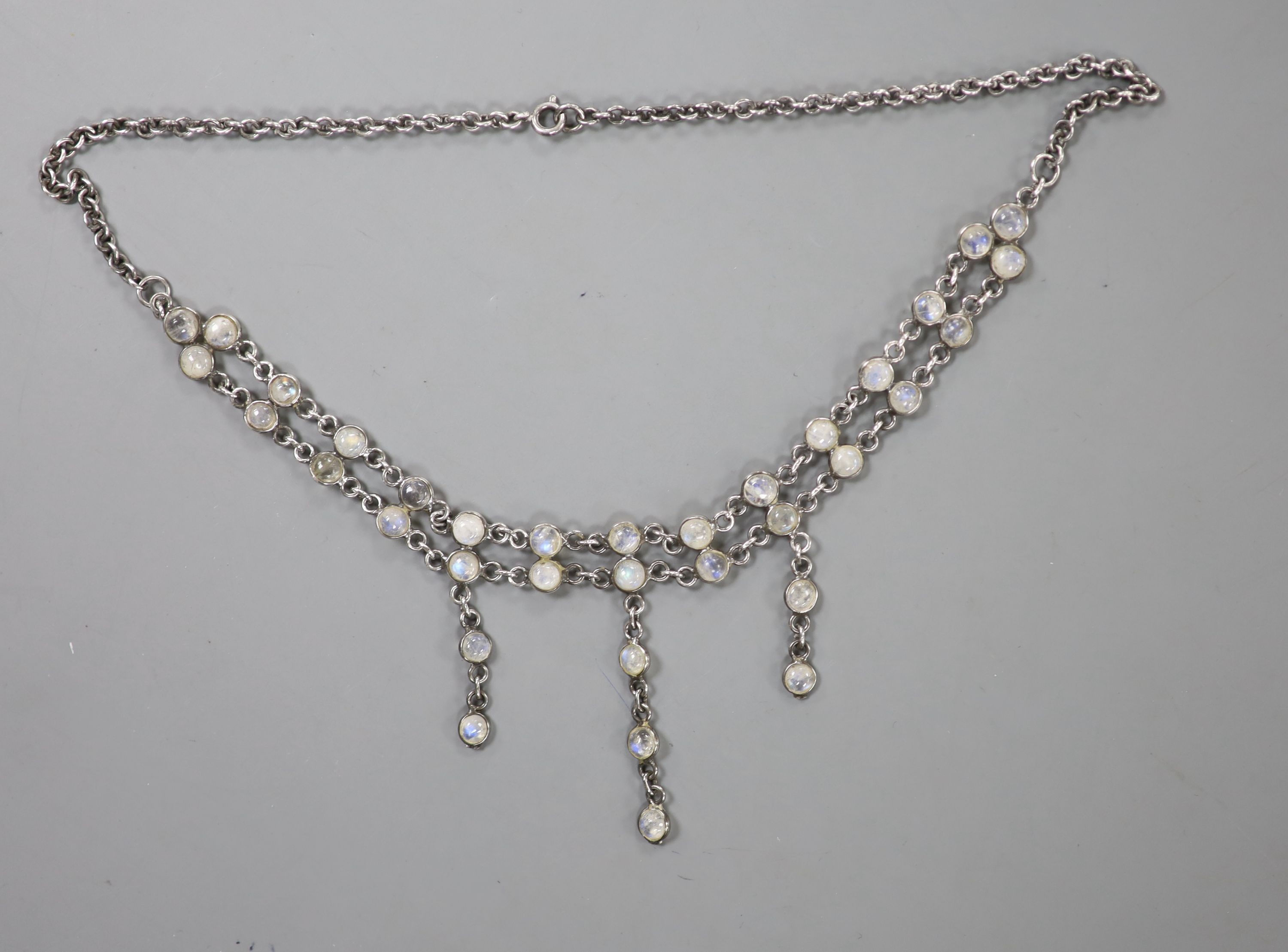 A white metal and cabochon moonstone set fringe drop necklace, approx. 42cm, excluding the drops.